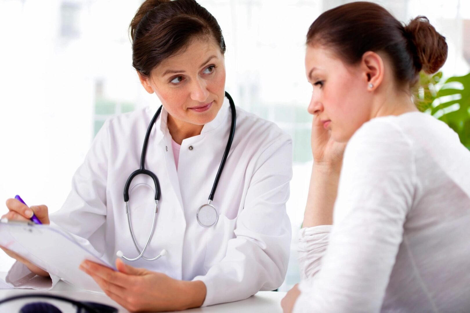 A woman talking to her doctor about something
